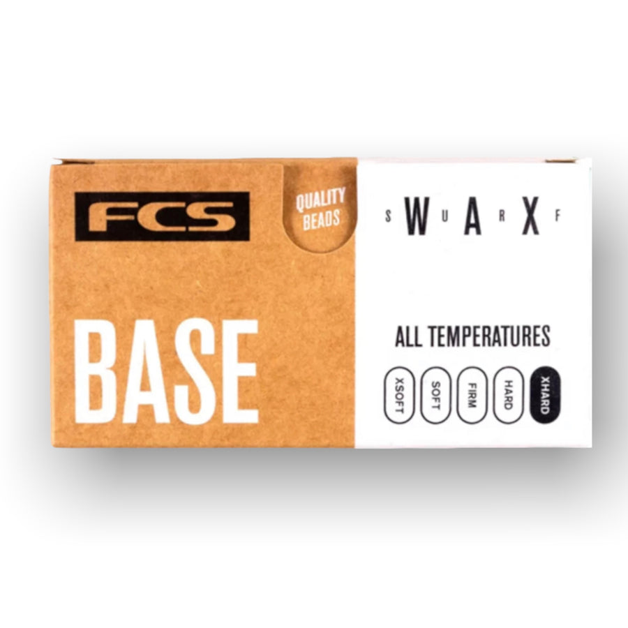 FCS Base Surfboard Wax in packaging, used as a foundation coat for long-lasting surf grip.